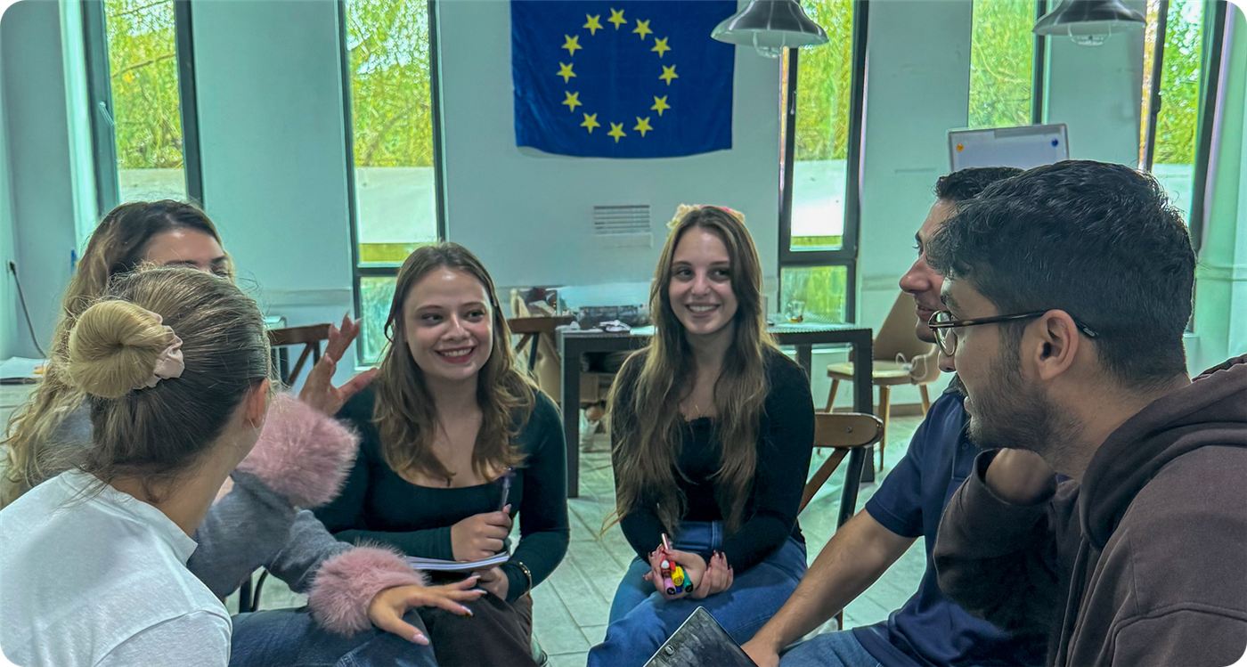 Participants in a non-formal education session under the EU flag